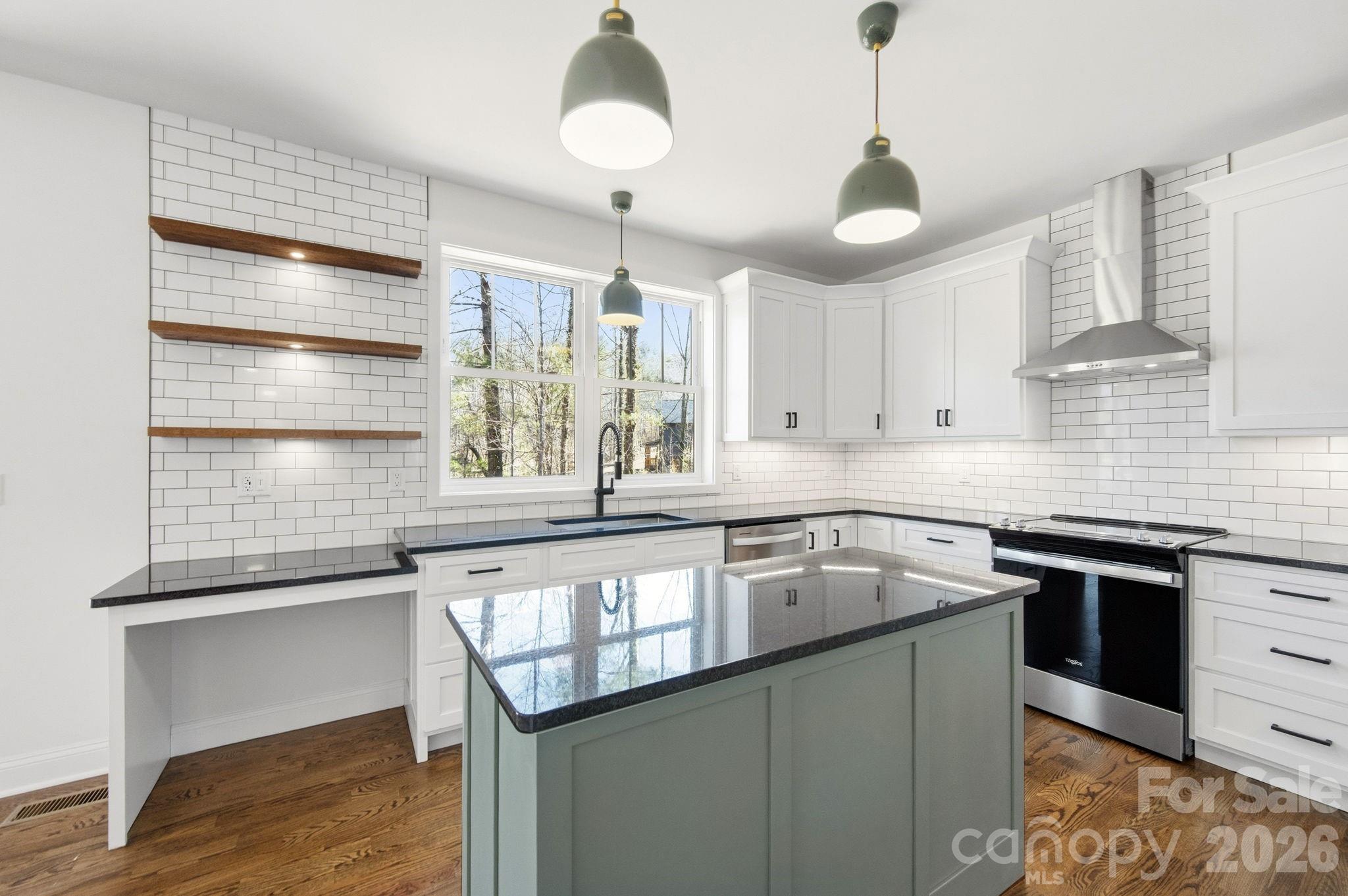 22 Deep Woods Road Weaverville, NC 28787 - Photo 7 of 37 a kitchen with stainless steel appliances granite countertop a sink a stove and a wooden floors