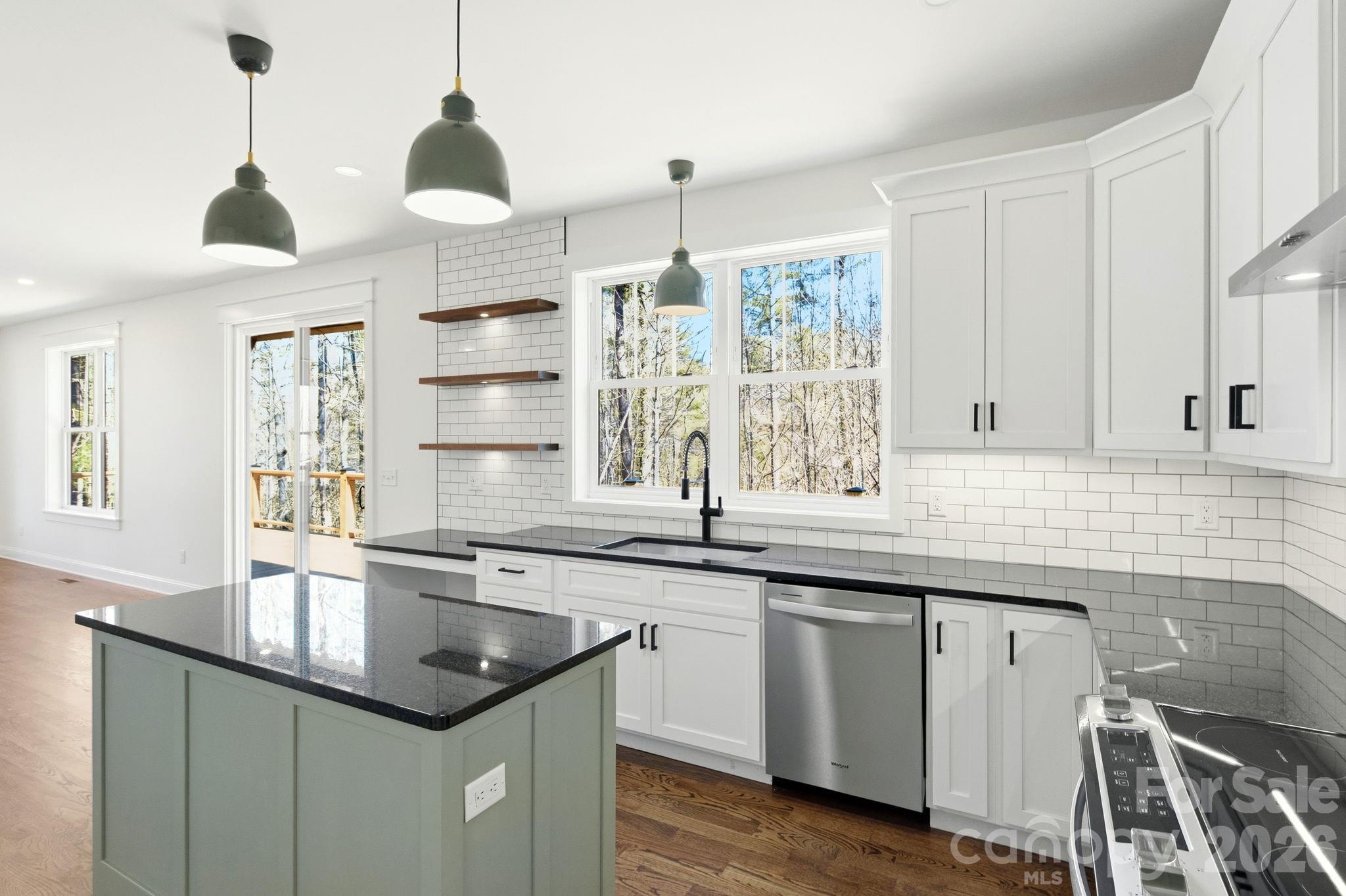 22 Deep Woods Road Weaverville, NC 28787 - Photo 8 of 37 a kitchen with stainless steel appliances granite countertop a sink a window and cabinets