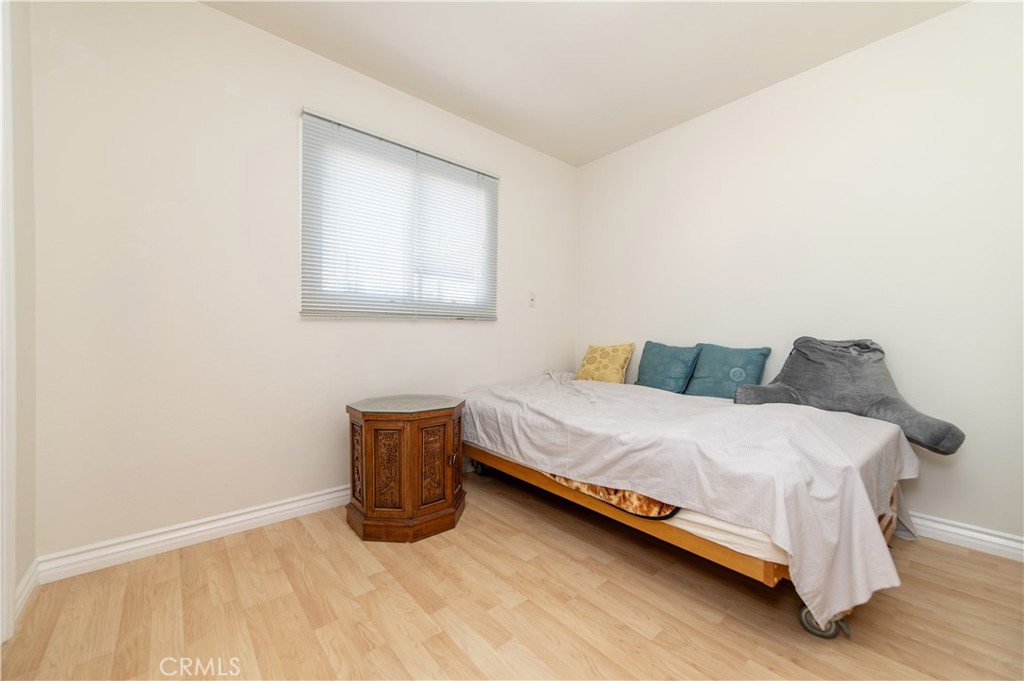 641 North Milford Road Orange, CA 92867 - Photo 14 of 25 a bedroom with a bed and wooden floor