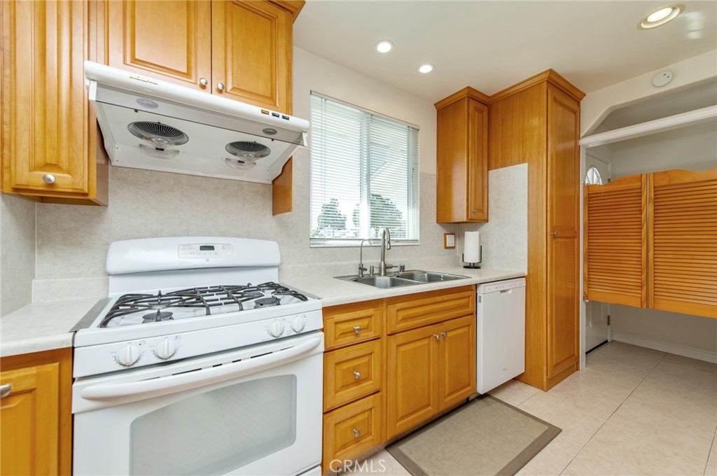 641 North Milford Road Orange, CA 92867 - Photo 8 of 25 a kitchen with stainless steel appliances granite countertop a stove a sink and a refrigerator