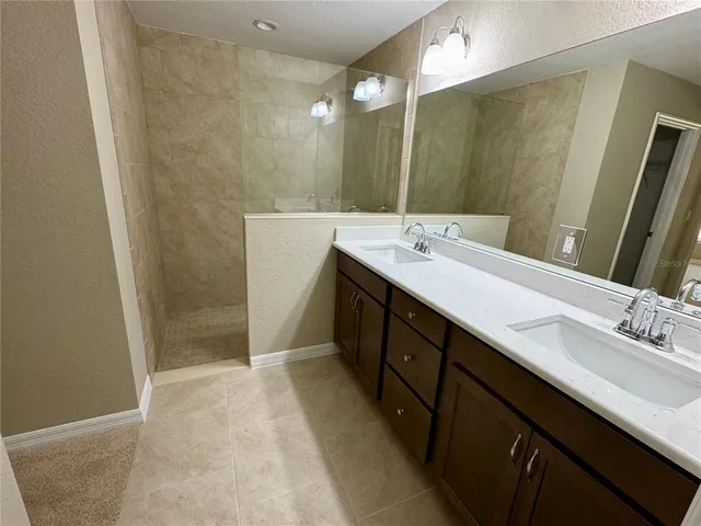 a bathroom with a double vanity sink a and mirror