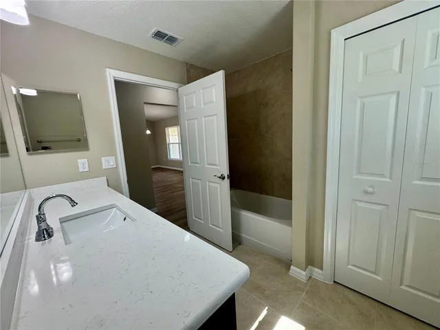 a en suite bathroom with a sink and a mirror