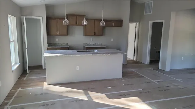 a bathroom with a granite countertop sink and vanity
