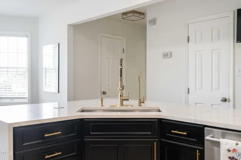 a kitchen with granite countertop white cabinets and stainless steel appliances