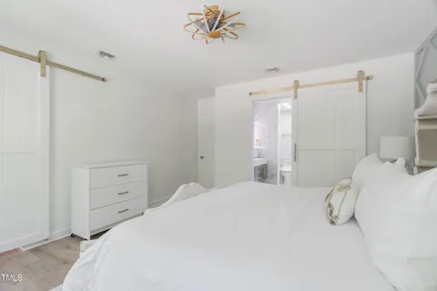 a bathroom with a double vanity sink a toilet and shower