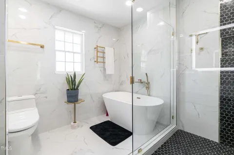 a bathroom with a toilet a sink and mirror