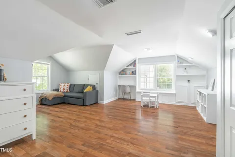 a bedroom with a bed and flat screen tv