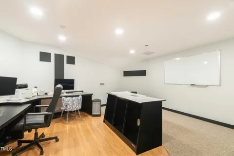 a bathroom with a granite countertop shower sink vanity and mirror