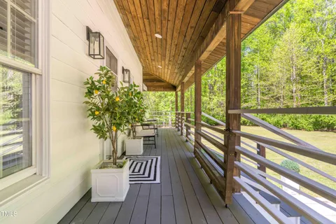 a living room with furniture a table and wooden floor