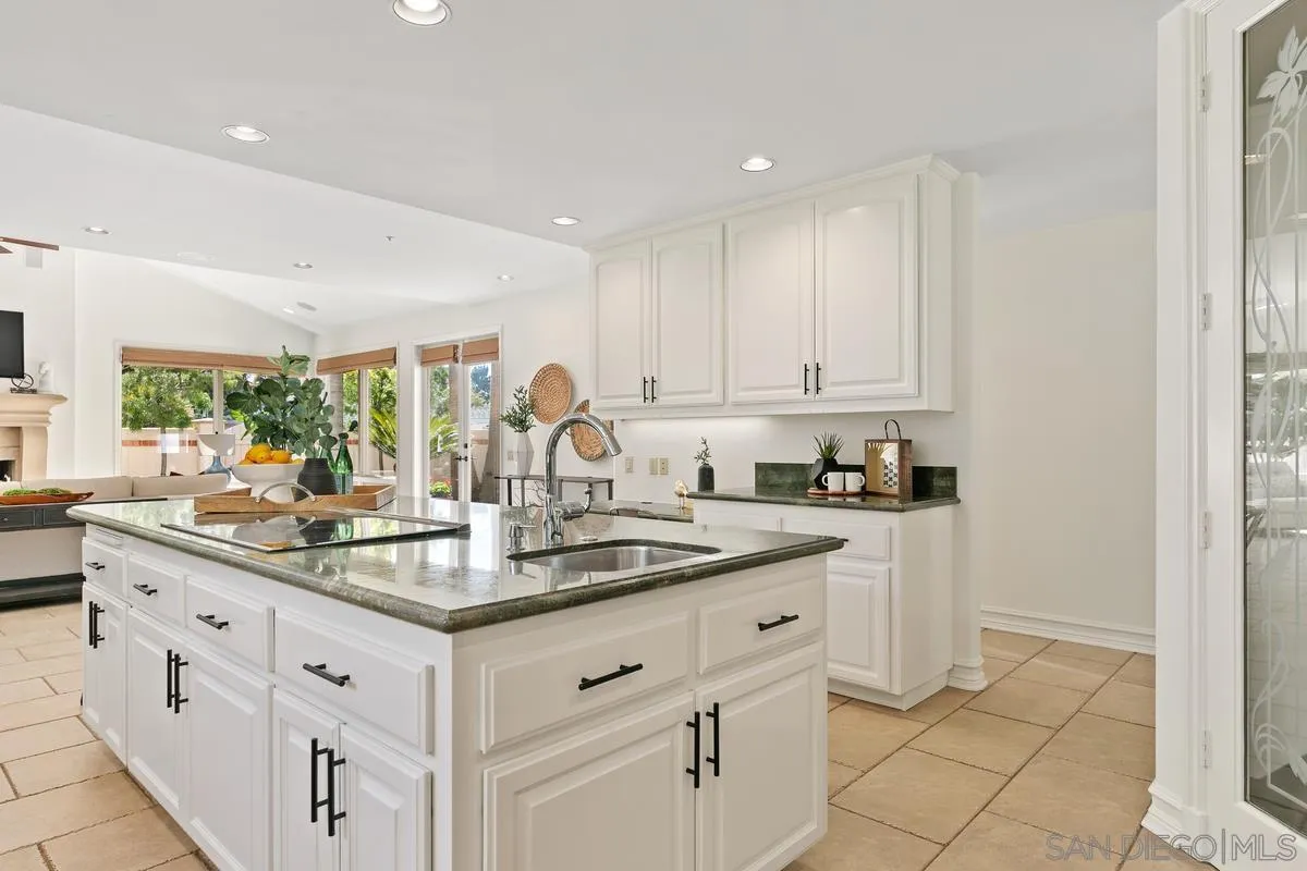 255 Cole Ranch Road Encinitas, CA 92024 - Photo 11 of 45 a kitchen with stainless steel appliances granite countertop a sink and cabinets