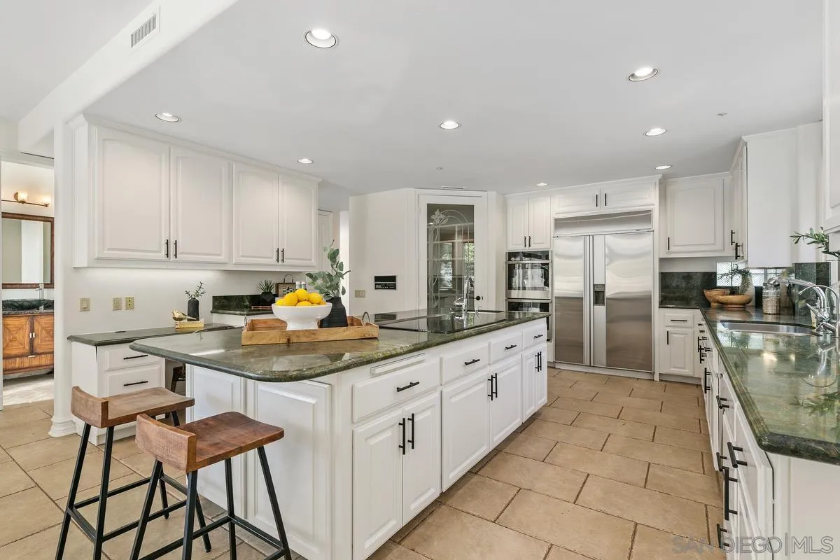 255 Cole Ranch Road Encinitas, CA 92024 - Photo 14 of 45 a kitchen with stainless steel appliances granite countertop a sink counter space and cabinets