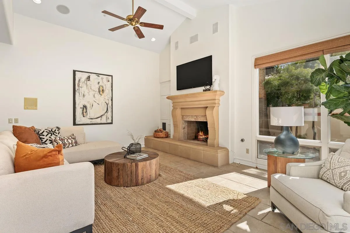 255 Cole Ranch Road Encinitas, CA 92024 - Photo 18 of 45 a living room with furniture a fireplace and a flat screen tv