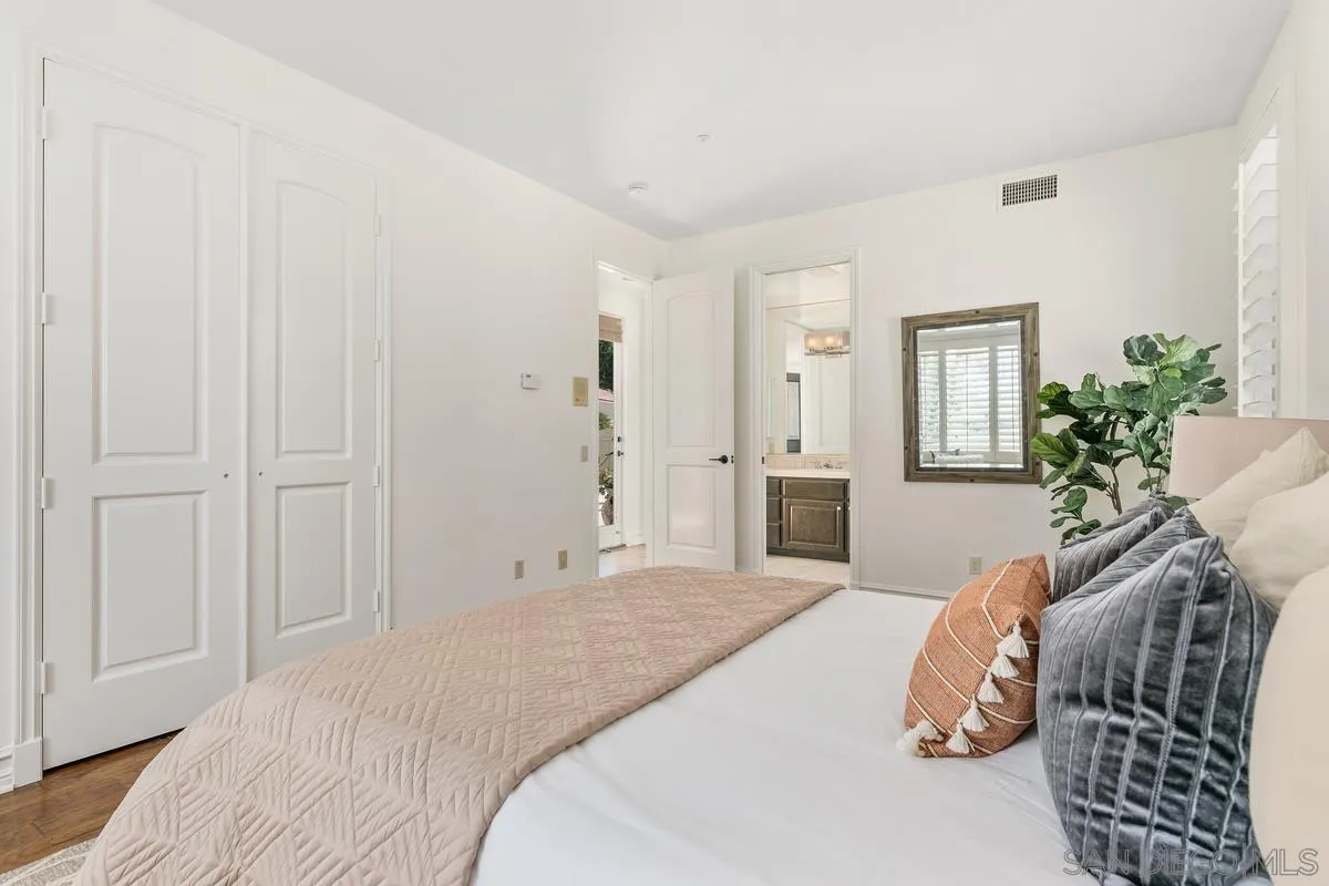 255 Cole Ranch Road Encinitas, CA 92024 - Photo 22 of 45 a bedroom with a bed and a potted plant