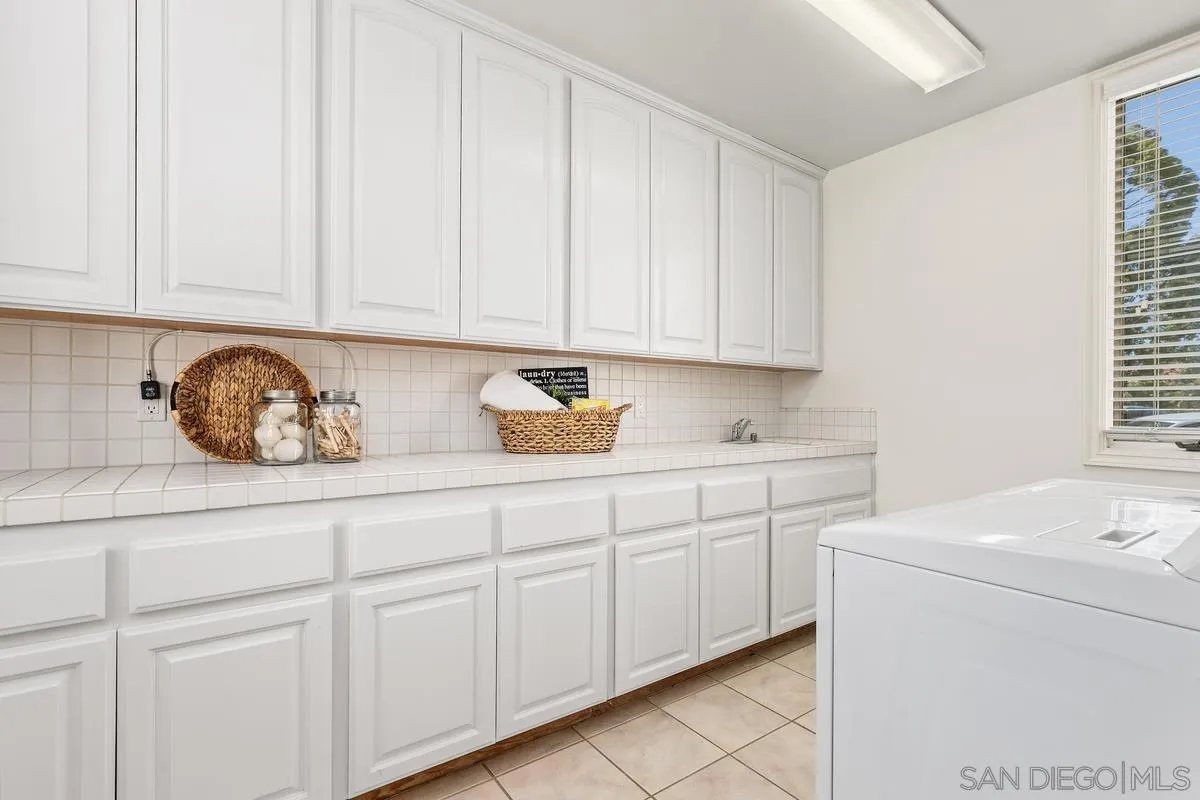 255 Cole Ranch Road Encinitas, CA 92024 - Photo 24 of 45 a kitchen with white cabinets and sink