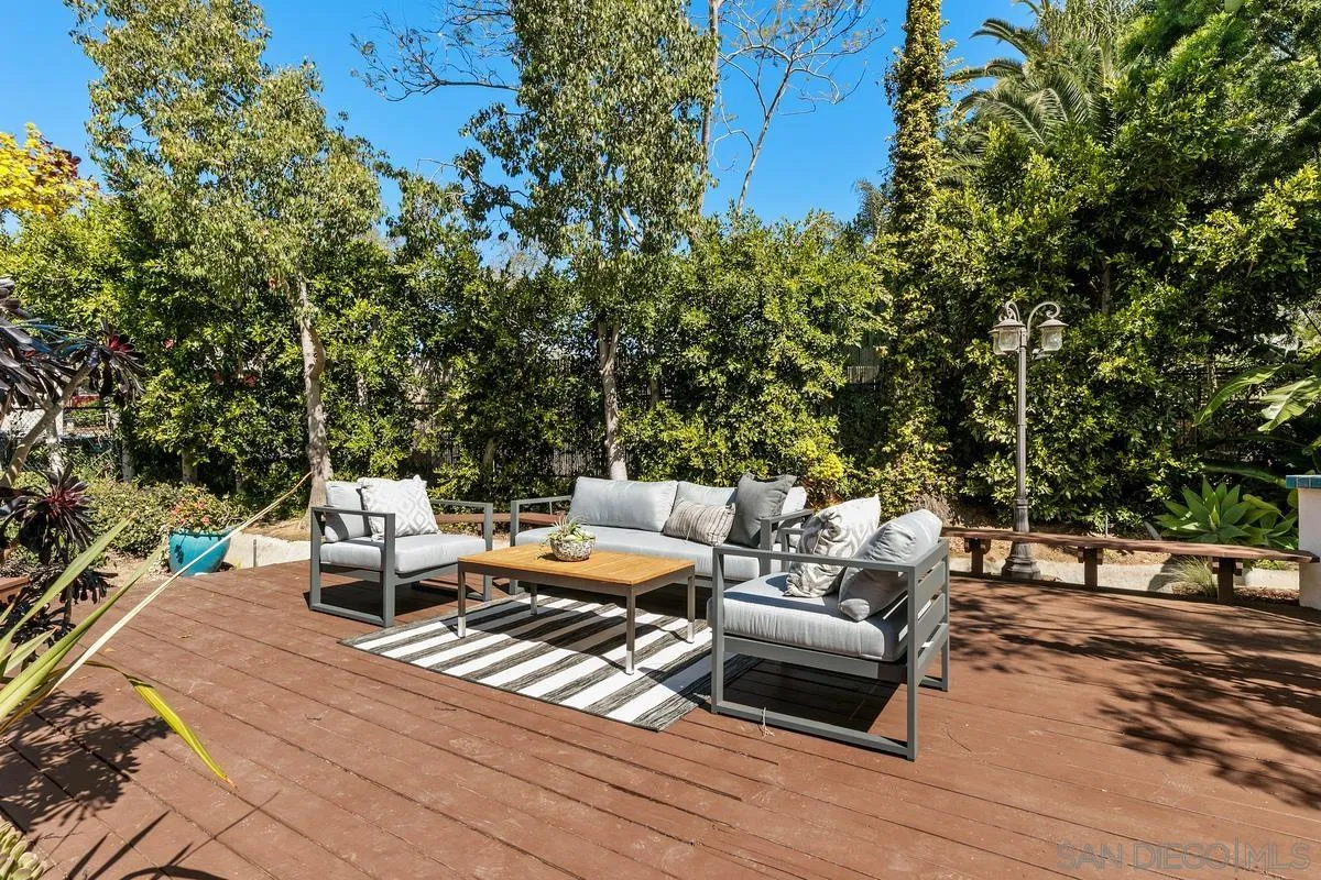 255 Cole Ranch Road Encinitas, CA 92024 - Photo 40 of 45 a view of a patio with couches and table and chairs next to yard with wooden floor