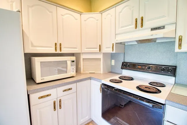 a kitchen with a stove and a microwave