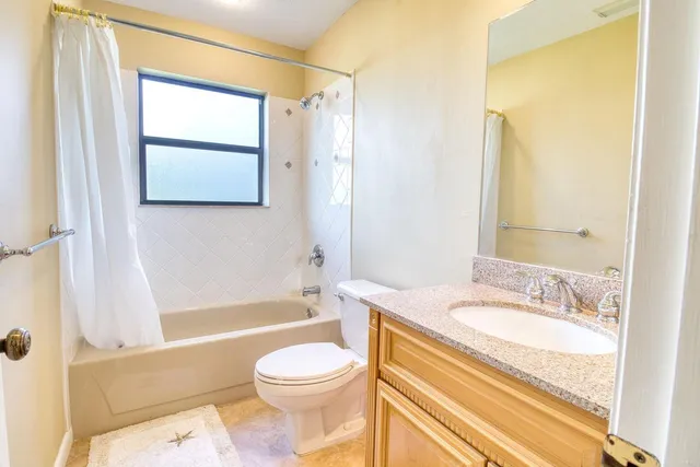 a view of a dining room with furniture and a window