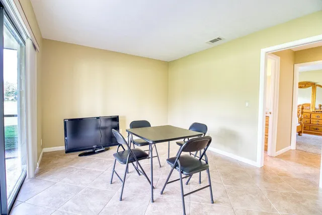 a dining room with furniture and window