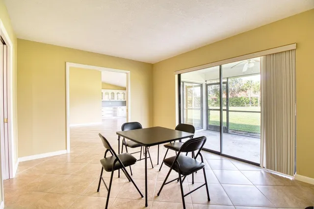 a view of a big room with floor to ceiling windows and an outdoor view