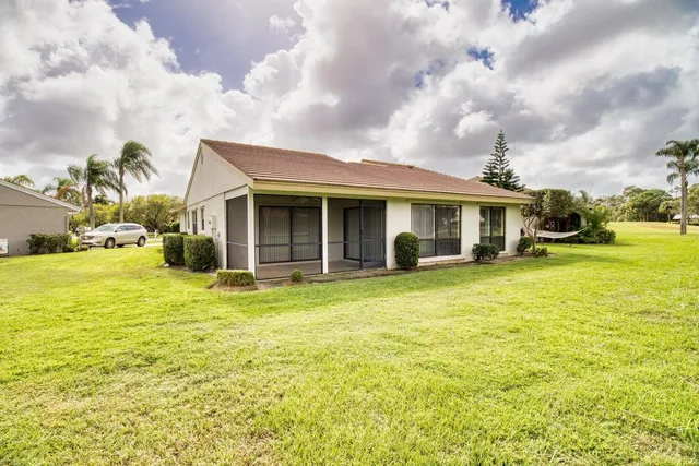 a view of a house with swimming pool and a yard
