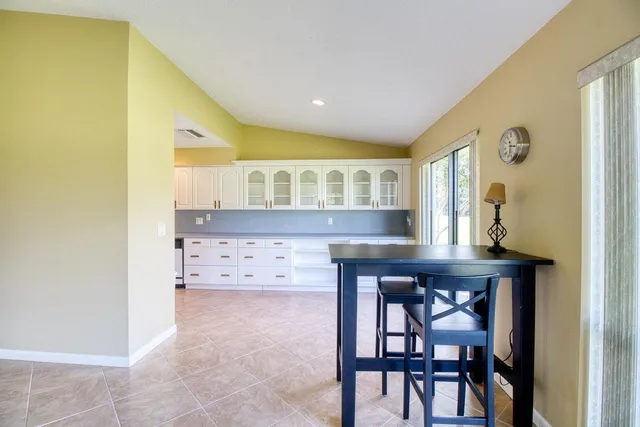 a view of kitchen with kitchen island dining table and chairs