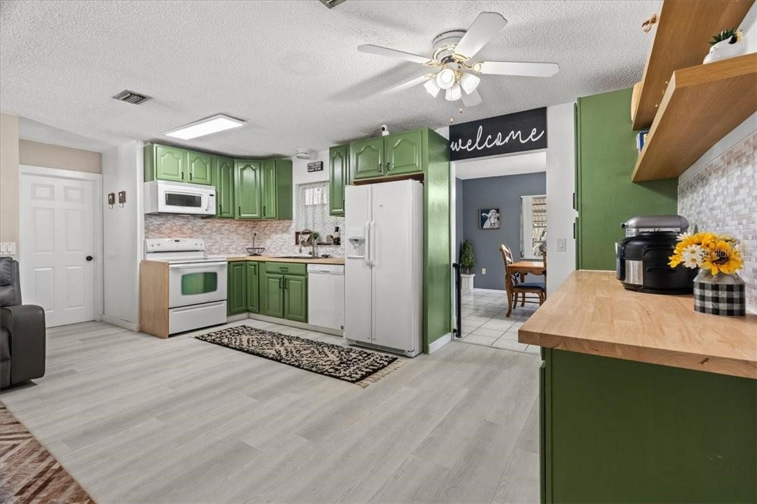 424 Wisconsin Avenue St. Cloud, FL 34769 - Photo 13 of 36 a kitchen with kitchen island a stove a refrigerator and a refrigerator
