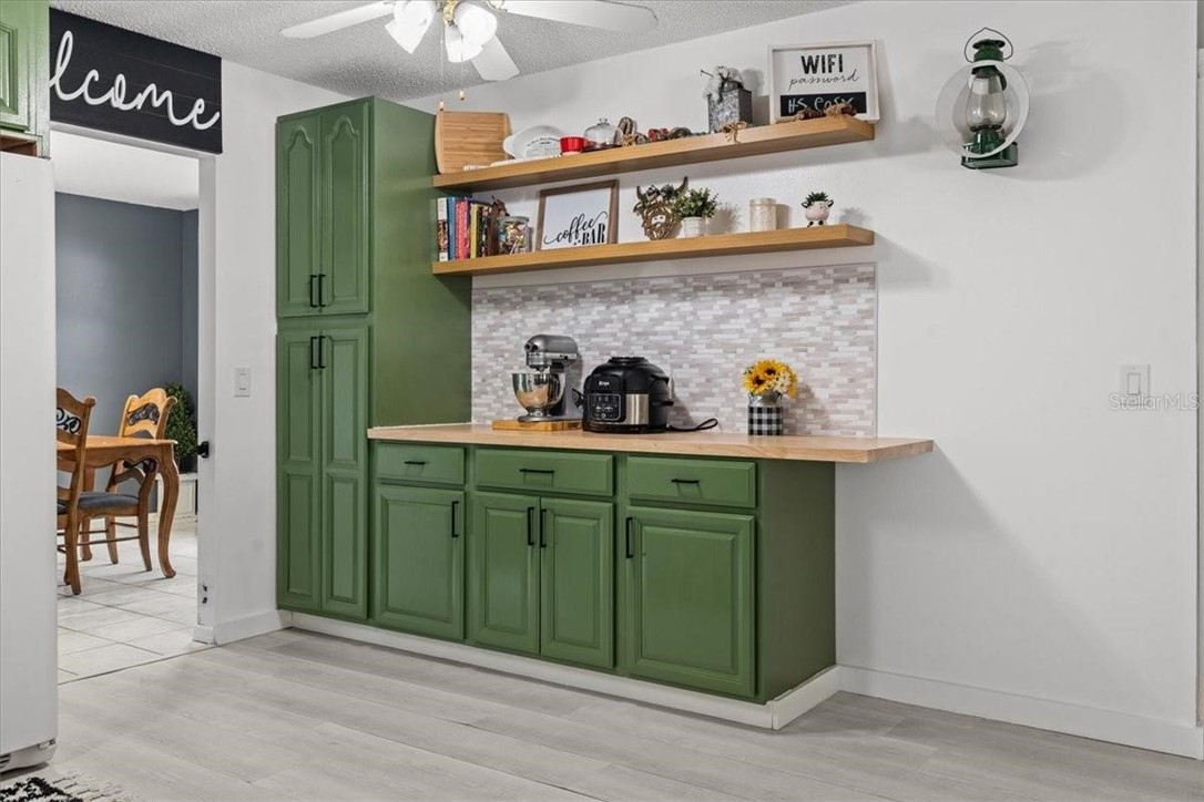 424 Wisconsin Avenue St. Cloud, FL 34769 - Photo 14 of 36 a kitchen with a refrigerator and cabinets