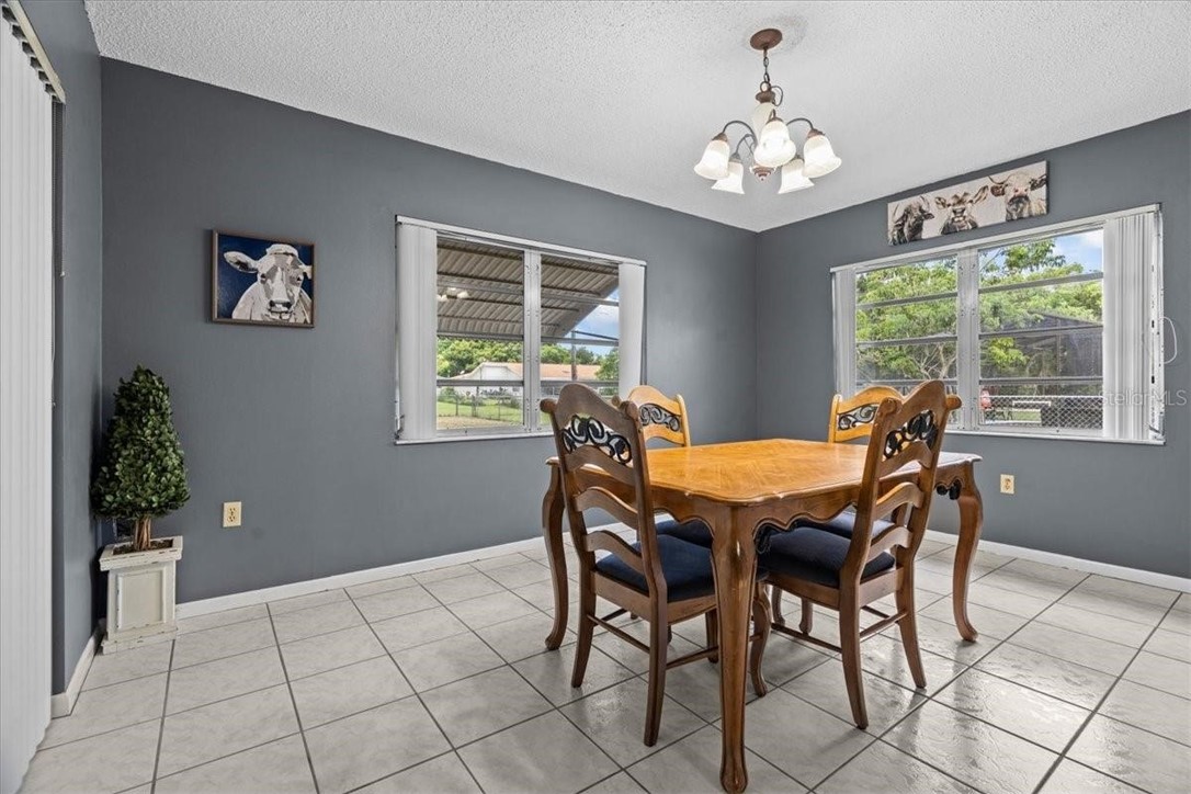 424 Wisconsin Avenue St. Cloud, FL 34769 - Photo 15 of 36 a view of a dining room with furniture a chandelier and window