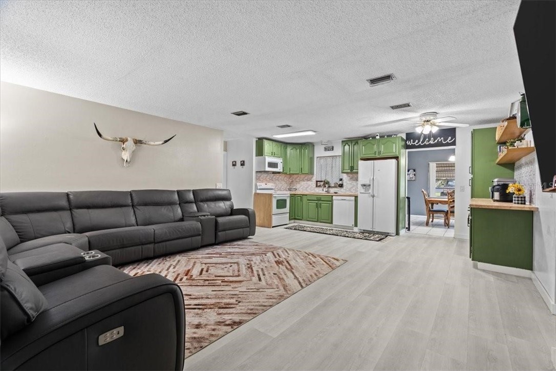 424 Wisconsin Avenue St. Cloud, FL 34769 - Photo 6 of 36 a living room with furniture window and a refrigerator