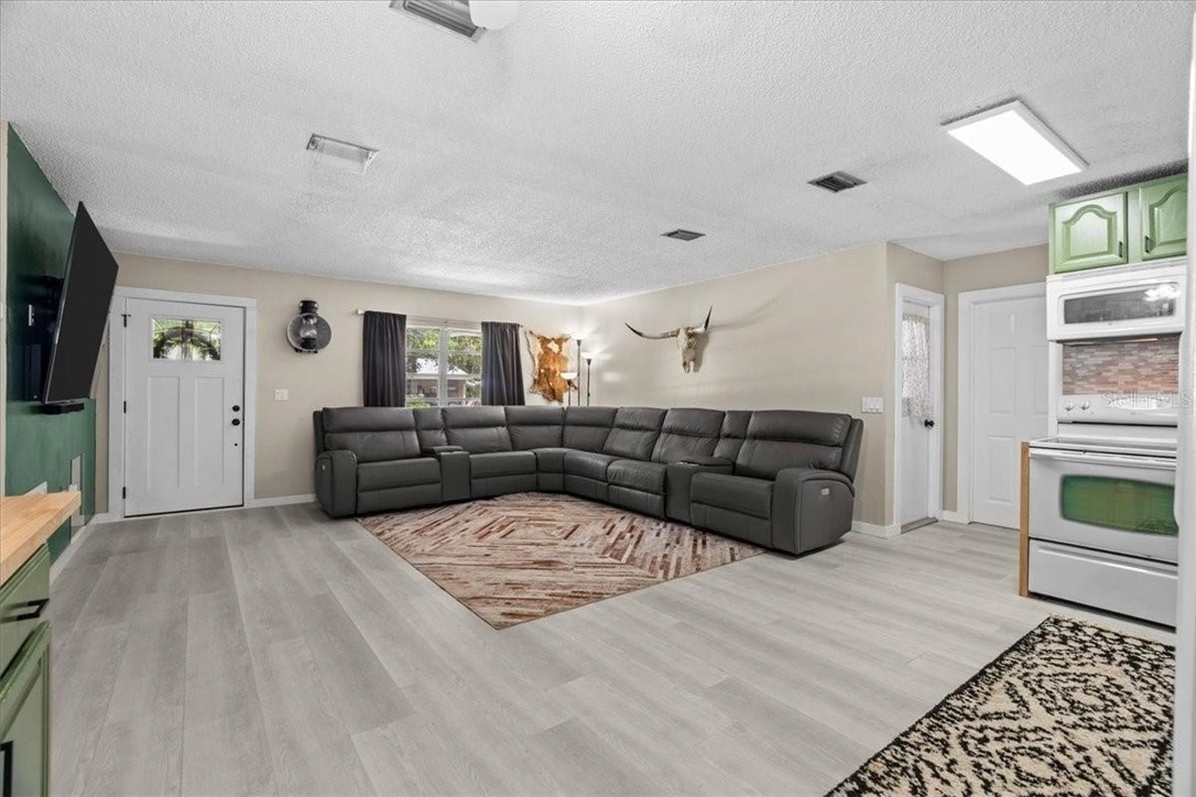 424 Wisconsin Avenue St. Cloud, FL 34769 - Photo 7 of 36 a living room with furniture and a flat screen tv