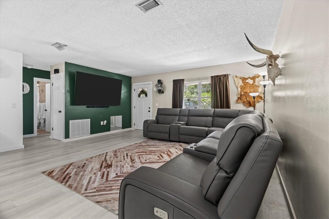 424 Wisconsin Avenue St. Cloud, FL 34769 - Photo 8 of 36 a living room with furniture and a flat screen tv