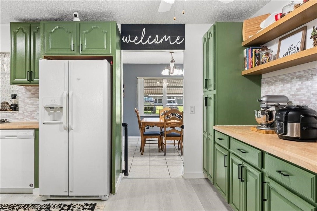 424 Wisconsin Avenue St. Cloud, FL 34769 - Photo 10 of 36 a kitchen with cabinets and a refrigerator