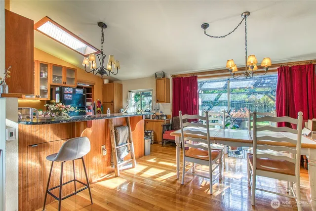 a kitchen with stainless steel appliances granite countertop a sink and a refrigerator