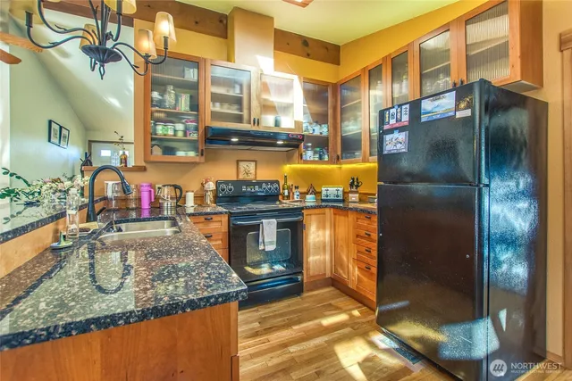 a living room with furniture a chandelier and a dining table