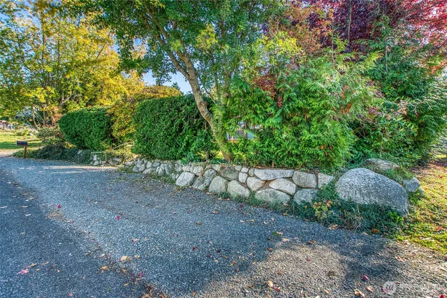a view of a house with a yard and a garden