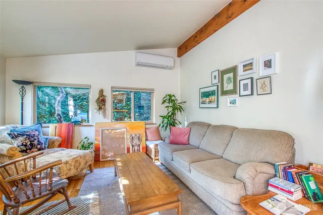 a view of a dining room with furniture a chandelier and wooden floor