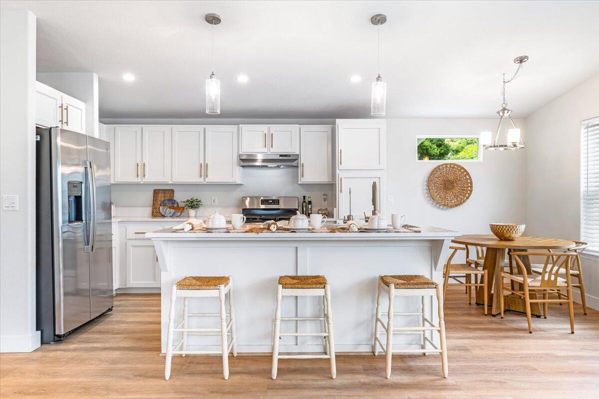 333 Old Mill Road, Unit SPC 157 Santa Barbara, CA 93110 - Photo 3 of 23 a kitchen with stainless steel appliances granite countertop a table and chairs in it