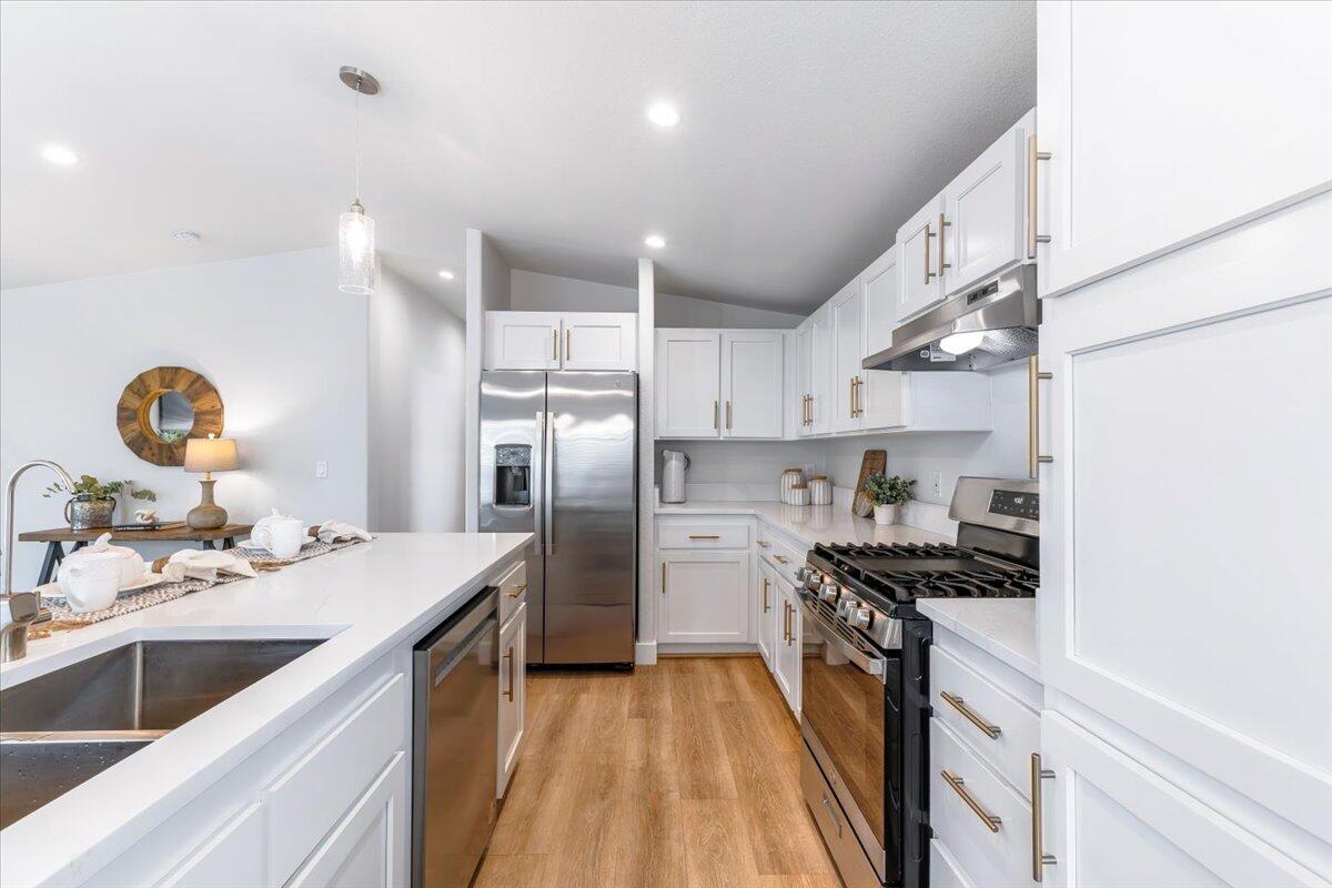333 Old Mill Road, Unit SPC 157 Santa Barbara, CA 93110 - Photo 4 of 23 a kitchen with kitchen island granite countertop a sink stainless steel appliances and cabinets