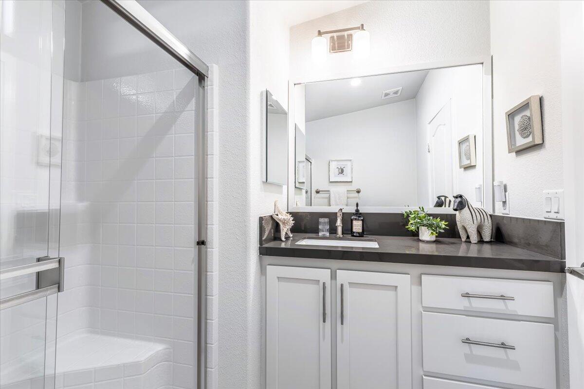 333 Old Mill Road, Unit SPC 157 Santa Barbara, CA 93110 - Photo 8 of 23 a bathroom with a granite countertop sink and a mirror