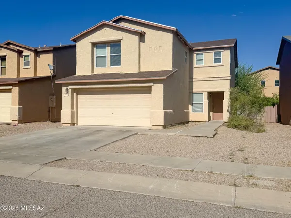 a front view of a house with a yard and garage
