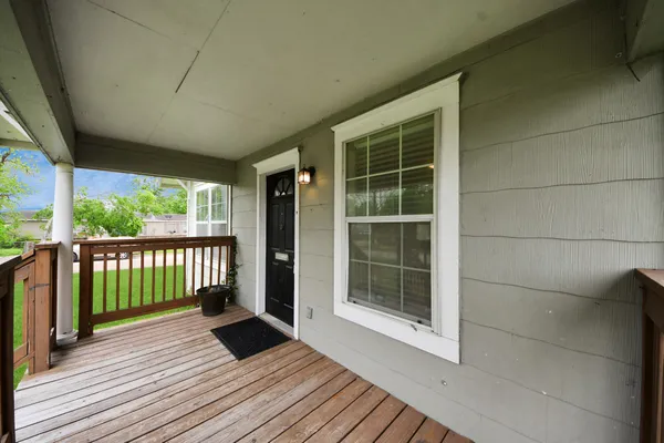 a view of a balcony with wooden floor
