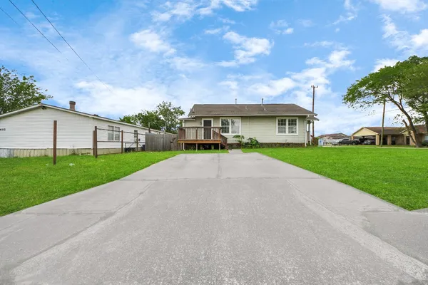a view of house with yard and green space
