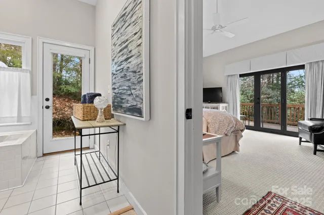 a bathroom with a granite countertop tub sink and mirror