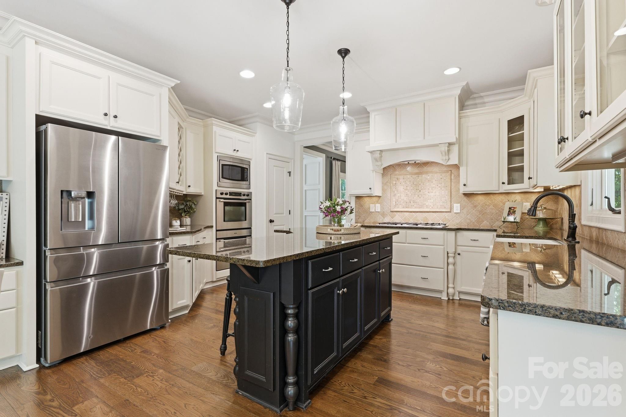 235 Grey Road Davidson, NC 28036 - Photo 7 of 42 a kitchen with stainless steel appliances granite countertop a sink refrigerator and cabinets