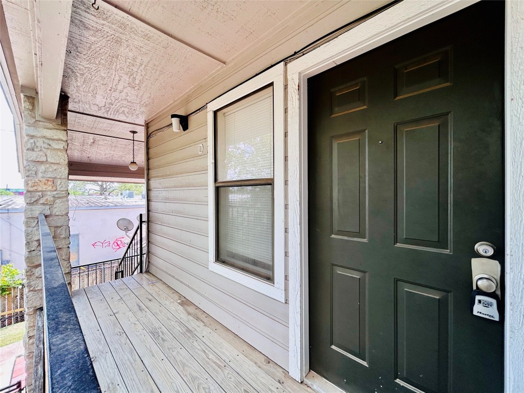 a balcony with furniture and wooden floor