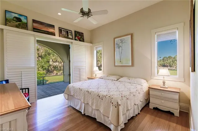 a open kitchen with stainless steel appliances granite countertop a stove top oven a dining table and chairs with wooden floor