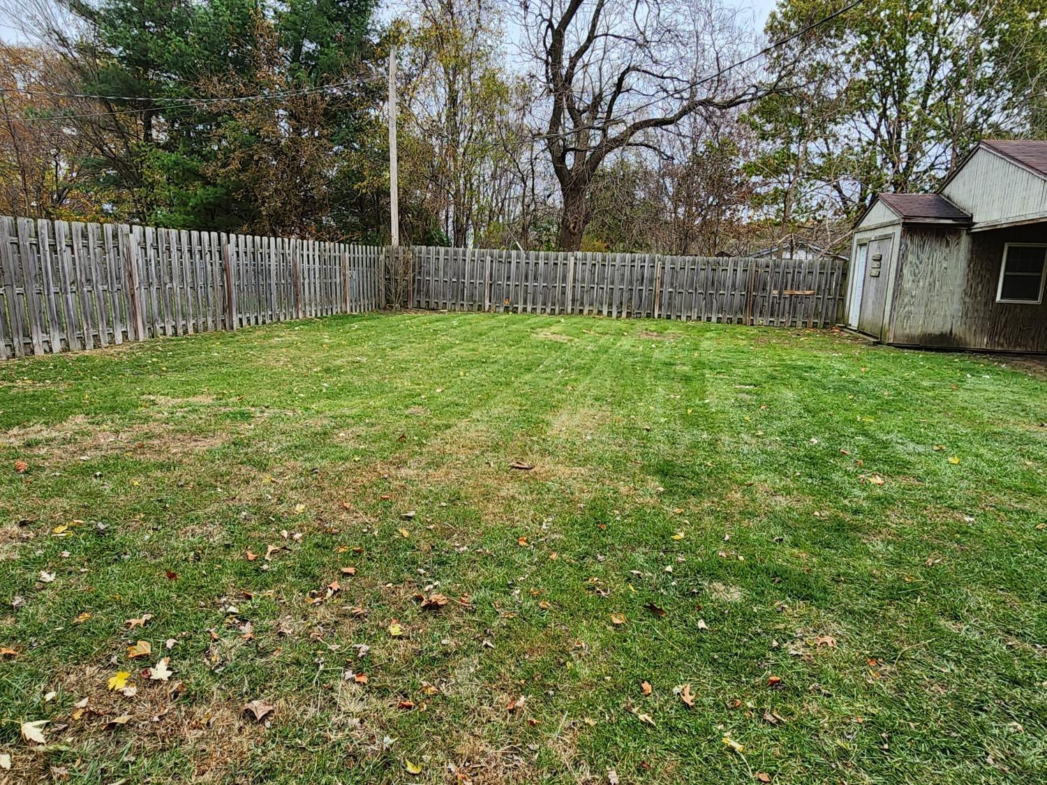 23809 Shelby Road Lowell, IN 46356 - Photo 44 of 48 a view of a backyard with a small cabin and a chair
