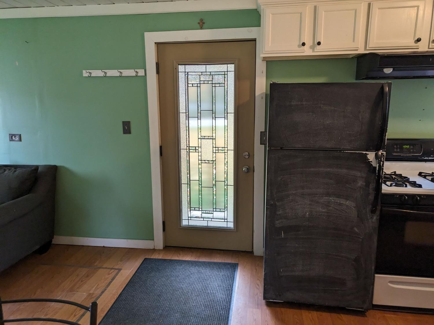 23809 Shelby Road Lowell, IN 46356 - Photo 9 of 48 a kitchen with a refrigerator and cabinets