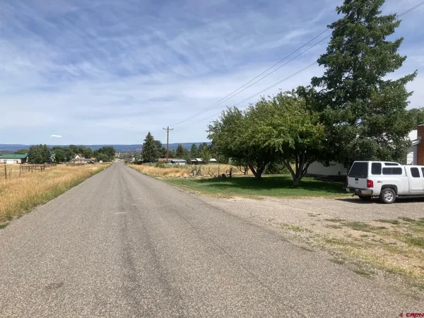 a view of a city street with a house