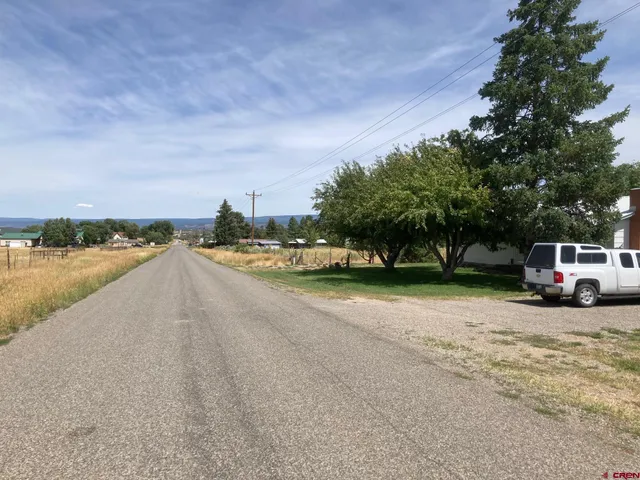 a view of a city street with a house